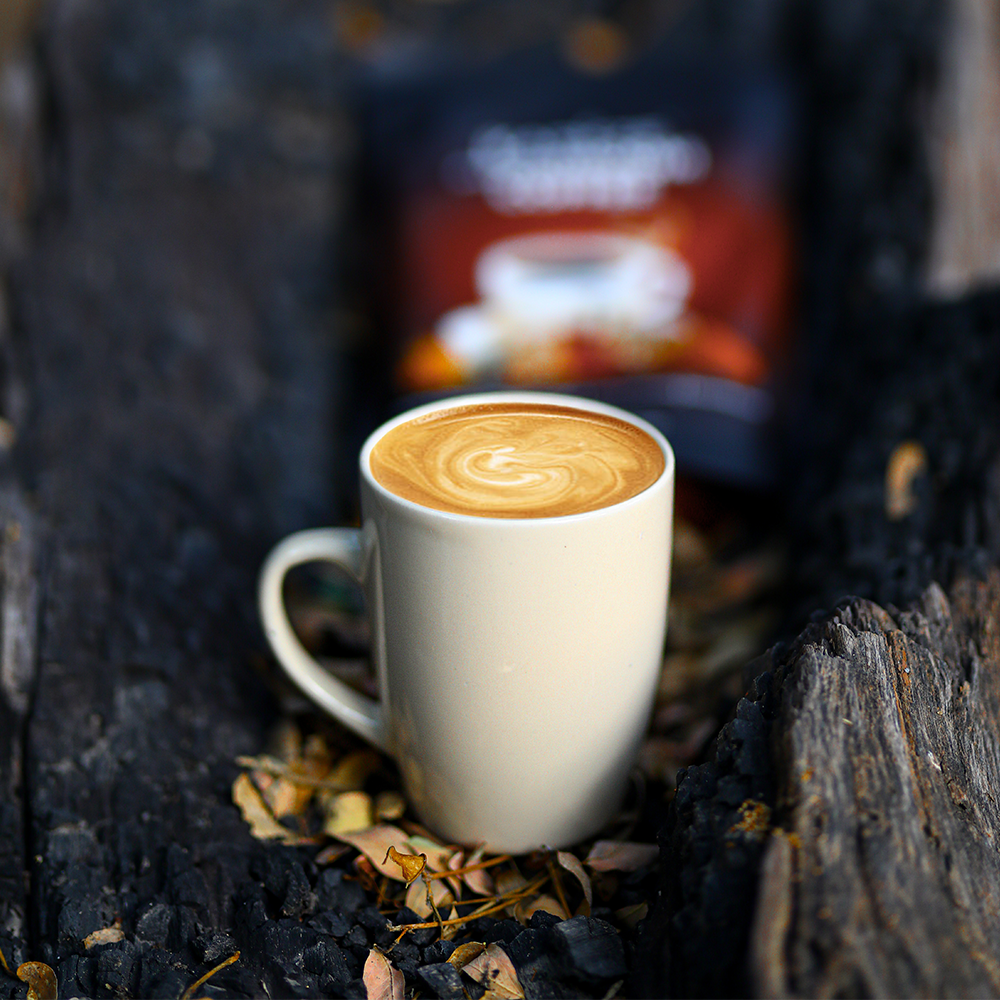 White mug with karkze coffee art on a wooden